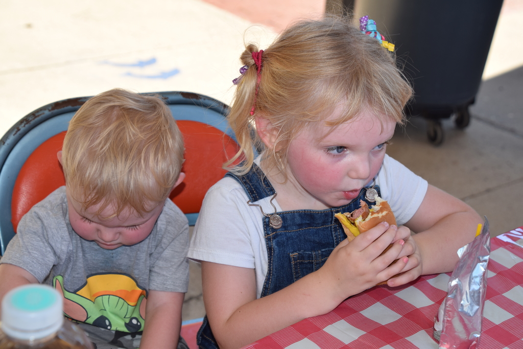 child eating hotdog