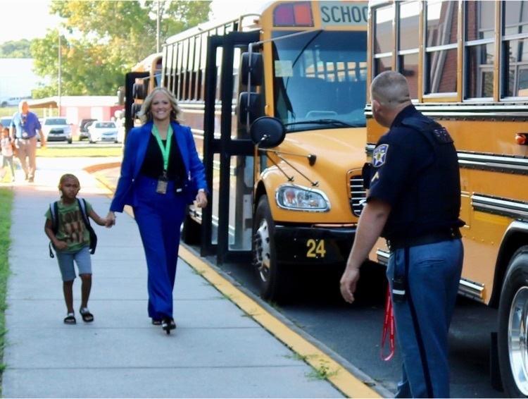 adult walking with child; bus