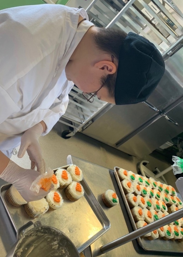 student making cupcakes