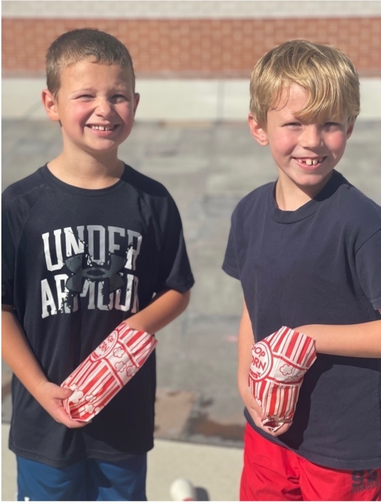 two boys eating popcorn
