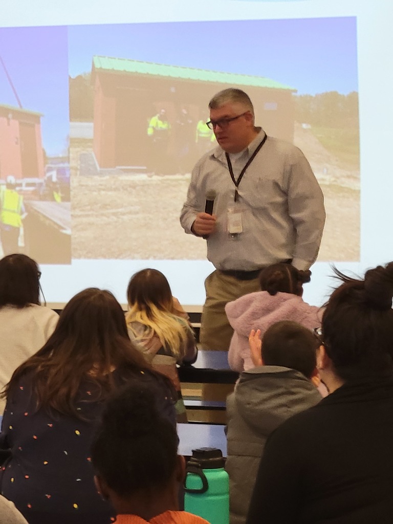 Mr. Johnson explains the installation of the Sharp Road bath house.