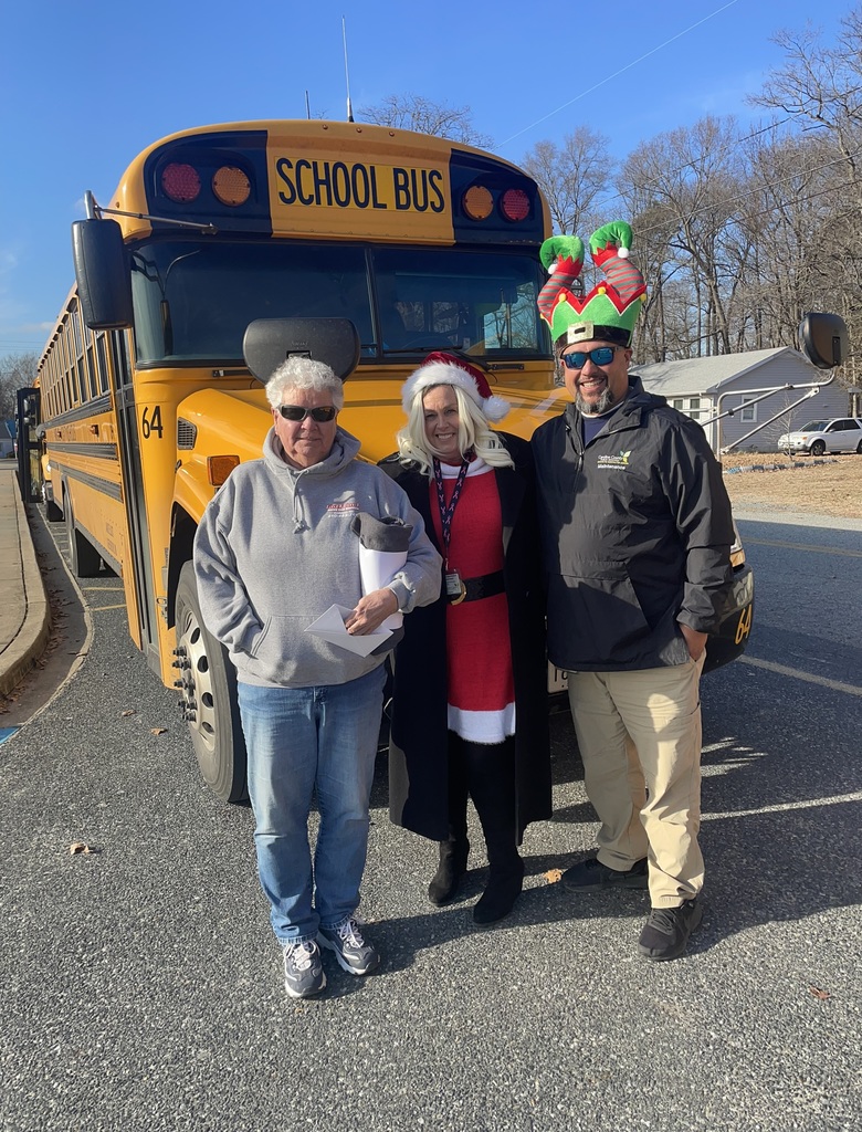 adults posing by bus