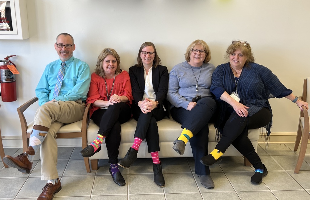 five people showing socks