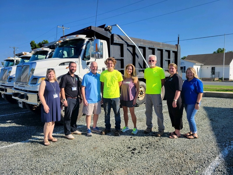 Staff, student, family and business photo by truck